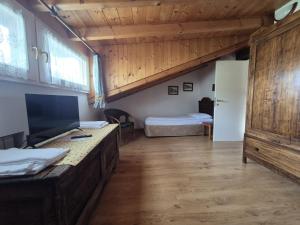a large room with a bed and a large window at Foresteria Traversi in Berbenno di Valtellina