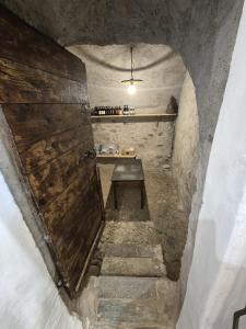 a stairway with a bench sitting in a tunnel at Foresteria Traversi in Berbenno di Valtellina +42 photos