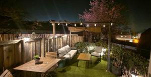 a patio with a table and chairs and a fence at Bed & Breakfast Moments in Schagen
