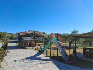 a playground with a slide in a park at Κτήμα Καρνέση 2 in Loutra Edipsou
