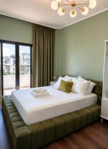 a bedroom with a large white bed with a large window at Sea Hotel in Ksamil +26 photos