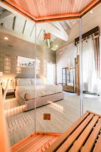 a bedroom with a bed with a glass wall at Boutique Casa Giulietta Desenzano in Desenzano del Garda