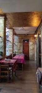 a dining room with two tables with pink tablecloths at HOTEL CASA RUSTICA Jr CALLAO 264 HUAMANGA AYACUCHO in Ayacucho