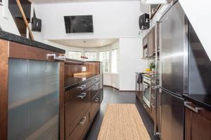 a kitchen with wooden cabinets and stainless steel appliances at Kasukkatie 2B in Tahkovuori