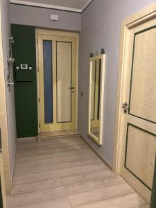 an empty room with a door and a mirror at Vicolo in Fiore House in Orvieto