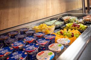 a buffet filled with chips and fruit and other food at Hotel Post by keyone in Bad Mitterndorf