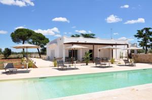 a villa with a swimming pool and a house at Dimora Thalèa - Retreat & Rooms in Nardò