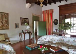 a living room with a couch and a table at Villa Maffei Rizzardi in Oppeano +60 photos