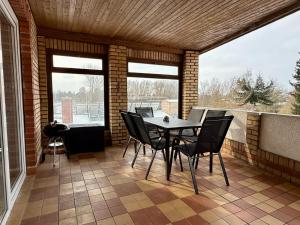 a patio with a table and chairs on a balcony at Gästehaus in Bad Sülze