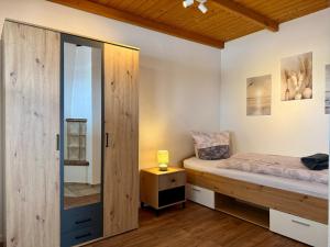 a bedroom with a bed and a sliding glass door at Gästehaus in Bad Sülze