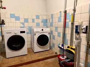 a laundry room with a washer and a washing machine at Gästehaus in Bad Sülze