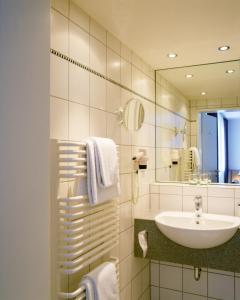 a bathroom with a sink and a mirror at Maternushaus in Cologne