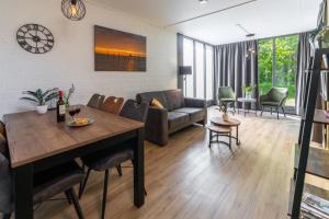 a living room with a table and a couch at 't Eibernest in De Cocksdorp