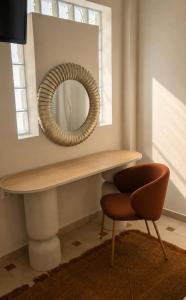 a table with a mirror and a chair at Sea Sun in Plomari
