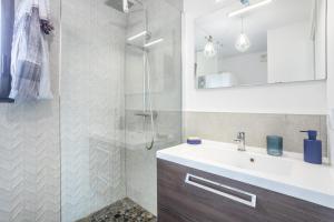 a bathroom with a sink and a shower at Villa Les Lodges Terre et Mer in Concarneau +73 photos