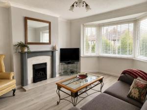 a living room with a couch and a fireplace at Amy's place in Warrington