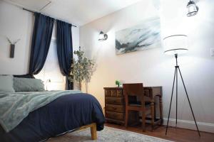 a bedroom with a bed and a desk and a chair at Cozy 3BR Coastal Retreat Private Yard & Fire Pit 5 Min to Beach! in Old Orchard Beach