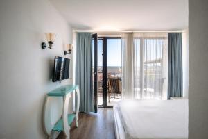 a bedroom with a bed and a window with a view at The Moon Vama Veche in Vama Veche