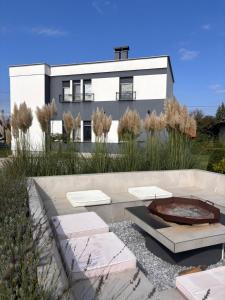 a house with a fire pit in front of it at Secret Place apartments, luxury and spa in Zdenci Brdovečki