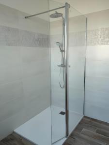 a glass shower door in a bathroom at Gîte 10 Couchages À Barfleur in Barfleur +19 photos