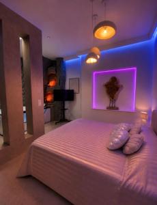 a bedroom with a large bed with purple lighting at Sanctuaire bien-être in Sélestat