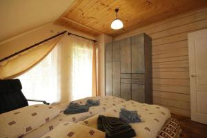 a bedroom with a bed with blue towels on it at Guest house Alyaska in Bukovel