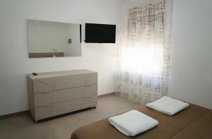 a bedroom with a bed and a dresser and a mirror at Casa vacanza Via Roma 103 in Crotone