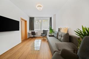 a living room with a couch and a flat screen tv at Apartment Absolon in Komín