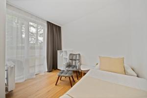 a bedroom with a bed and a chair at Apartment Absolon in Komín