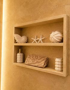 a shelf with seashells and other items on it at Sanctuaire bien-être in Sélestat +29 photos