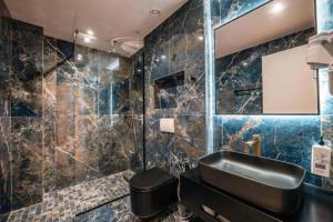 a bathroom with a sink and a toilet at Cuni Luxury Hotel in Sarandë +93 photos