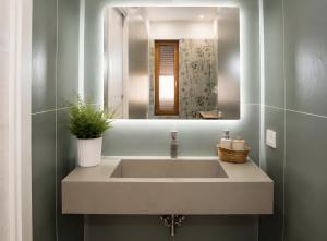 a bathroom with a sink and a mirror at Casa vacanza Via Roma 103 in Crotone +20 photos