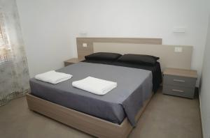 a bedroom with a bed with two pillows on it at Casa vacanza Via Roma 103 in Crotone