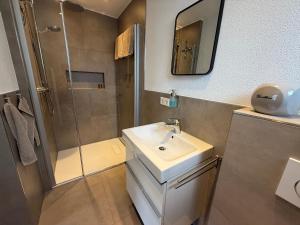 a bathroom with a sink and a shower at Urlaub Schwarzwaldliebe in Bad Teinach-Zavelstein +19 photos