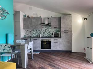 a kitchen with a table and a dining room at Attico Vicky in Porto Azzurro