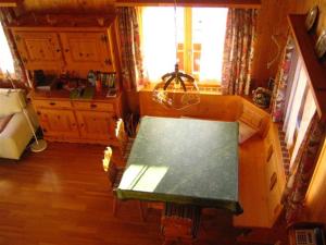a living room with a table and a couch at Chalet Heinzenberg in Urmein +13 photos