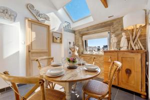 a dining room with a wooden table and chairs at Gite Ti Arzou in Le Conquet