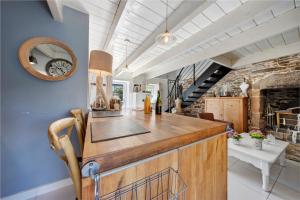 a kitchen with a large wooden counter and blue walls at La maisonette Ti Arzou in Le Conquet