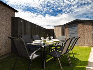 a black table and chairs on a patio at Lazy Daize in Saint Merryn