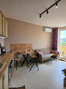 a kitchen and living room with a couch and a table at Апартамент Туида 2 in Sliven
