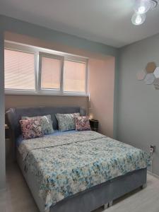 a bedroom with a large bed with pillows at Апартамент Туида 2 in Sliven