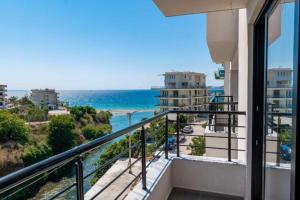 a balcony with a view of the ocean at Cuni Luxury Hotel in Sarandë