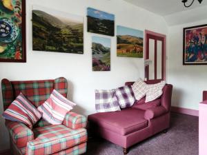 a living room with a couch and a chair at Tŷ Melindwr in Capel Bangor