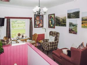 a living room with a couch and chairs and a table at Tŷ Melindwr in Capel Bangor