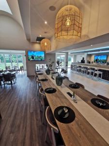 a dining room with a long table and chairs at Town Lodge George in George