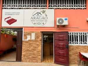 an entrance to aarmaarmaarma restaurant with a red door at Pensão Aragão & Lima in São Tomé