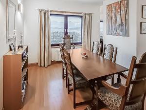 a dining room with a table and chairs and a window at Sealladh Lingeigh in Pollachar +19 photos