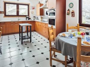 a kitchen with a table and a dining room at Sealladh Lingeigh in Pollachar