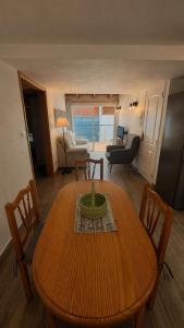 a living room with a wooden table and a living room at Atico el Wiro in Puerto