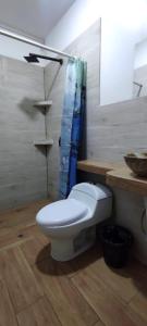 a bathroom with a white toilet and a sink at HOTEL CASA RUSTICA Jr CALLAO 264 HUAMANGA AYACUCHO in Ayacucho